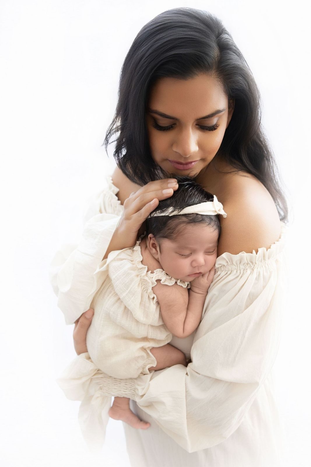 Mother holding her sleeping newborn against her shoulder